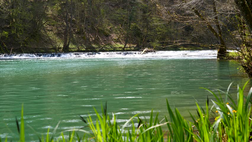 Low static shot of a small quick flowing rapid on the Krka River