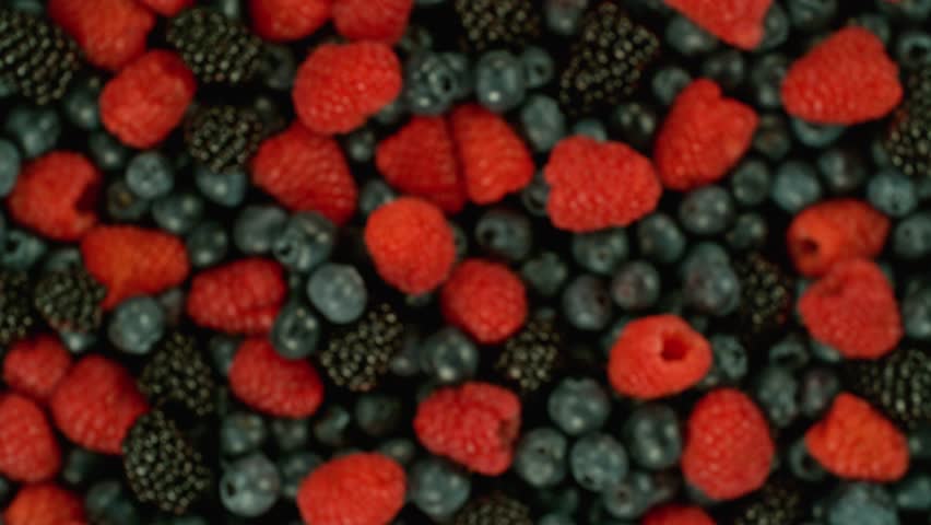 Super slow motion of rotating berries in the air, top view. Filmed on high speed cinema camera, 1000 fps. Royalty-Free Stock Footage #1103050279