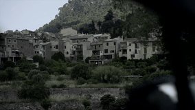 Moving handheld view of a spanish rural houses from a vehicle in the road. 
