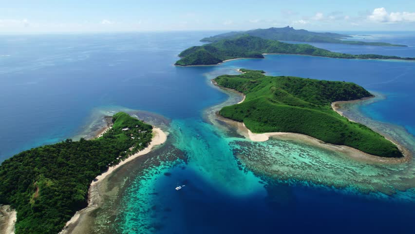 Flying high over the Yasawa islands Fiji and it's coral reefs. Royalty-Free Stock Footage #1103051529