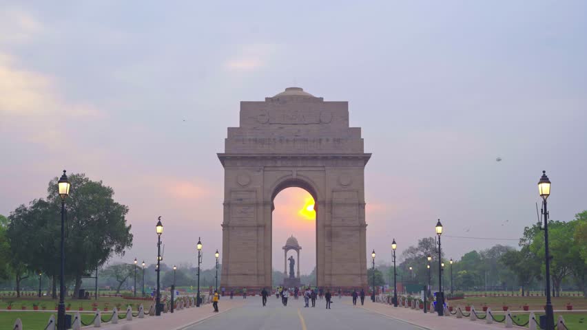 Beautiful sunrise at iconic India Gate on Kartavya Path with tourists and locals enjoying the view, New Delhi, India Royalty-Free Stock Footage #1103051561