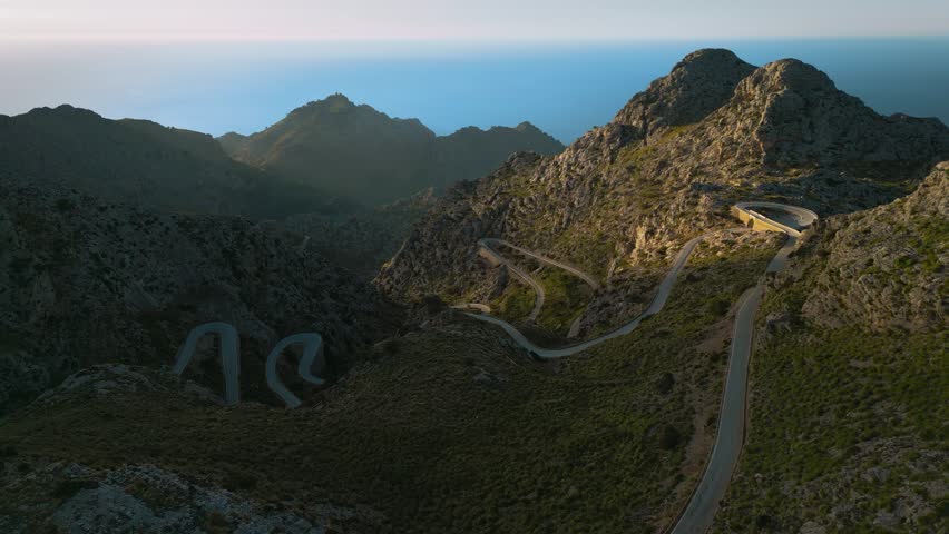 Hairpin Bend Sa Calobra, Palma de Mallorca. Serpentine curve road in the mountains near Soller. Scenic Majorca Island nature aerial drone footage. Famous for racing bikes cycling. Cinematic 4K UHD.