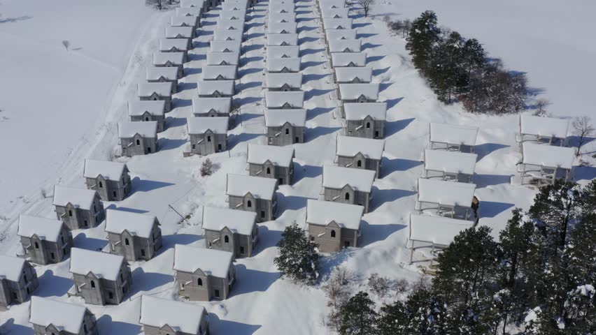 Identical houses covered in snow precisely lined up, aerial drone fly over Royalty-Free Stock Footage #1103056187