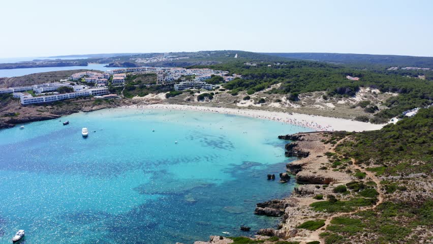Luxury beach front properties line the coast line of Son Parc beach in Menorca.