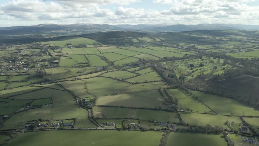 Vast Green Fields Near The Windmill Hill Quarry In Rathcoole, Dublin, Ireland. - aerial pullback