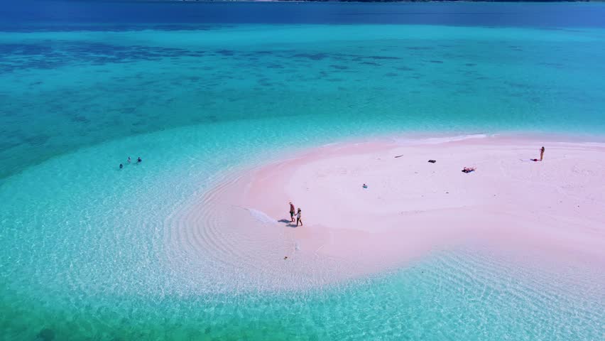 North point beach a sand bar at Koh Lipe Island Satun Thailand with a tropical beach and turqouse colored ocean. A couple of men and women walking on a sandbank in the blue ocean of Ko Lipe Royalty-Free Stock Footage #1103060707