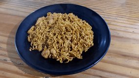 Video of hot steam from a plate of fried noodles served on a black plate 