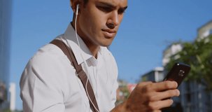Animation of financial data processing over biracial man using smartphone. Global connections, business, finances, computing and data processing concept digitally generated video.