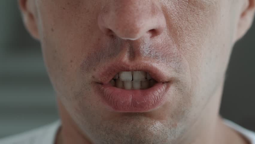 Shout, close up male face yelling or angry face expression. Close up mouth of angry man screaming and shouting, feeling anger and stress in bad mood. Royalty-Free Stock Footage #1103065103
