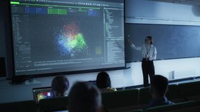 Young University Professor Explaining the Importance of Artificial Intelligence to a Group of Diverse Students in a Dark Auditorium. Female Teacher Showing Big Data Ecosystem on Two Big Screens - Powered by Shutterstock - Get 15% off with code: PIKWIZARD15