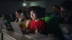 Beautiful Multiethnic African Female Student Studying in University with Diverse Classmates. Young Black Woman Using a Laptop Computer. Applying Her Knowledge to Acquire Academic Skills in Class - Powered by Shutterstock - Get 15% off with code: PIKWIZARD15