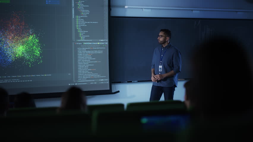 Portrait of a Young Male Teacher Giving a Data Science Lecture to Diverse Multiethnic Group of Female and Male Students in Dark College Room. Projecting Slideshow with a Neural Network Model Royalty-Free Stock Footage #1103067005