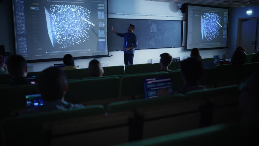 Young Male Teacher Giving a Data Science Lecture to Diverse Multiethnic Group of Female and Male Students in Dark College Room. Projecting Slideshow with Artificial Intelligence Network Architecture Royalty-Free Stock Footage #1103067023