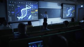 Young University Professor Explaining a DNA Sequencing Methods to a Group of Diverse Multiethnic Students in a Dark Auditorium. Female Teacher Showing a Macro Image of a DNA Structure on a Big Screen - Powered by Shutterstock - Get 15% off with code: PIKWIZARD15