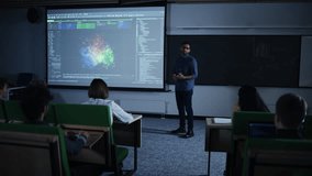 Young Male Teacher Giving a Data Science Lecture to a Diverse Multiethnic Group of Female and Male Students in a Dark College Space. Projecting Slideshow with a Neural network Model - Powered by Shutterstock - Get 15% off with code: PIKWIZARD15