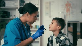 Pediatrician examining little boy's throat, routine health check-up for kids - Powered by Shutterstock - Get 15% off with code: PIKWIZARD15
