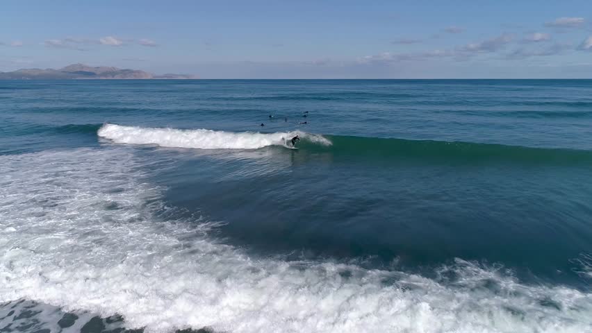 A thrilling moment captured in this aerial footage of a surfer wiping out. Experience the rush of surfing and the beauty of the ocean from above.