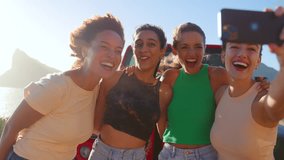 Female friends posing for selfie laughing in front of car on road trip through countryside - shot in slow motion - Powered by Shutterstock - Get 15% off with code: PIKWIZARD15