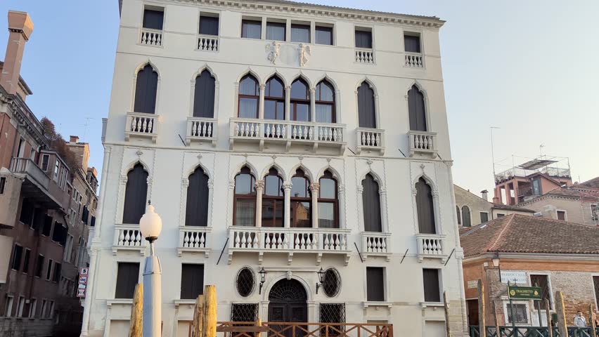 Traveling with boat on the grand canal in Venice, passing Hotels and other buildings