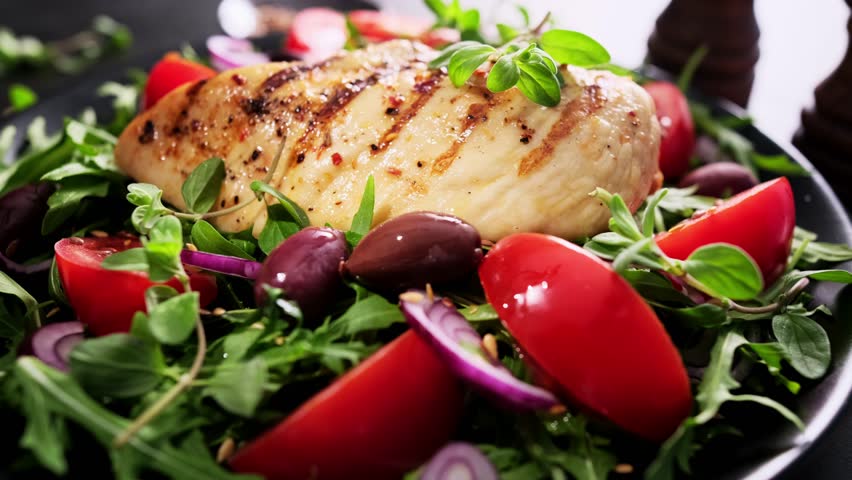Salad with fresh vegetables and grilled chicken breast Royalty-Free Stock Footage #1103073545