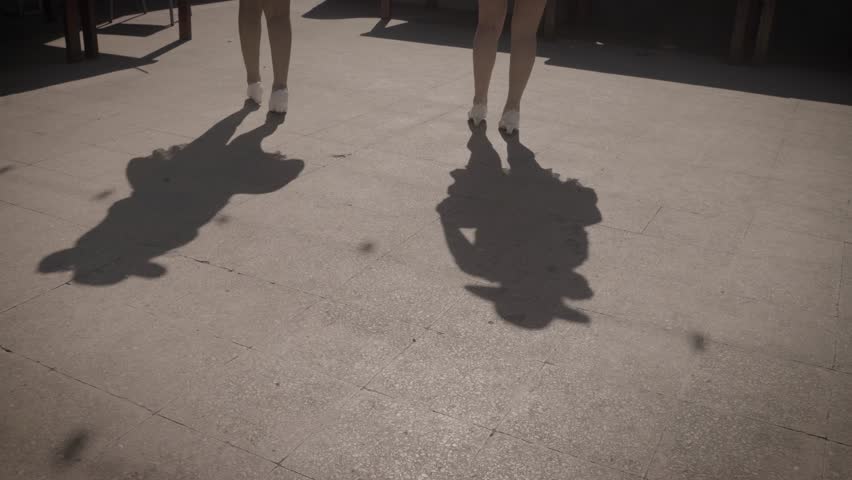 A close up footage of dancing Bolivian performers casting their shadows on the ground. Royalty-Free Stock Footage #1103074527