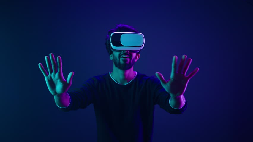 Metaverse virtual reality cyberspace world man play game playing guy meta universe experience digital technology with VR goggles helmet cyber gamer neon ultraviolet futuristic space cyberpunk gaming Royalty-Free Stock Footage #1103075023