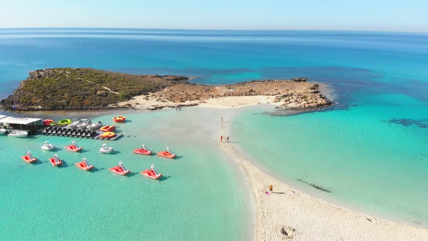 Nissi beach in Ayia Napa, clean aerial view of famous tourist beach in Cyprus. Destination on island and formed from a smaller island just near the main shore Royalty-Free Stock Footage #1103076891