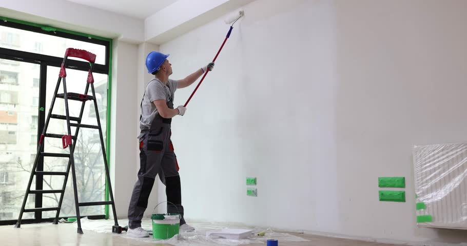 House painter paints wall white with roller Royalty-Free Stock Footage #1103079185