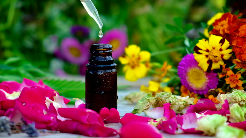 Bottled herbal and flower tinctures. Selective focus. Nature.