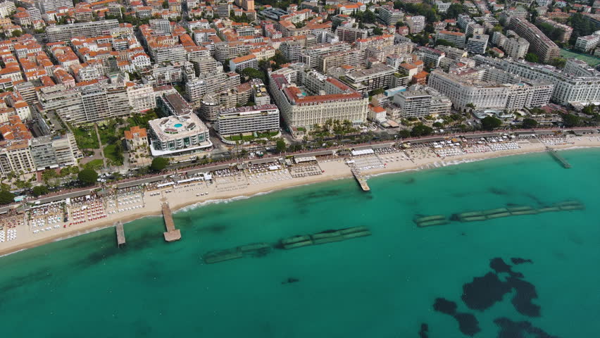 Aerial panorama of Cannes, Cote d'Azur, France, South Europe. Luxury resort and city of French riviera. Famous tourist destination ft nice beach and Promenade de la Croisette on Mediterranean sea UHD Royalty-Free Stock Footage #1103080815