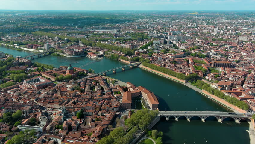 Toulouse city and Garonne river aerial panoramic view. It's the capital of southern France Occitanie region. Historical landmark Dome de La Grave from above in Haute Garonne on a summer day 4K UHD Royalty-Free Stock Footage #1103080817