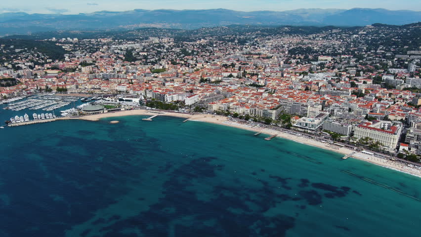 Aerial panorama of Cannes, Cote d'Azur, France, South Europe. A resort town on the French Riviera is famed for its international film festival. Its Boulevard de la Croisette, coast with sandy beaches Royalty-Free Stock Footage #1103080823