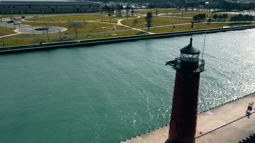 Red lighthouse standing on the shores of Lake Michigan. Lighthouse by the lake.