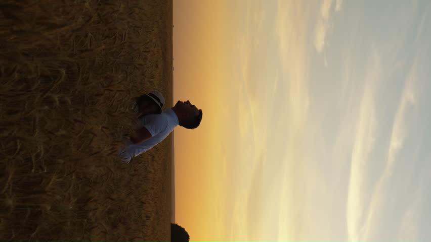 Vertical Screen: Family having fun in wheat field at sunset. Slow motion dad throwing daughter up in the air. Happy people enjoying time together in nature. Concept of love and father day Royalty-Free Stock Footage #1103085641