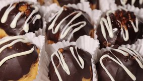 Profiteroles with chocolate cream and glaze macro video
