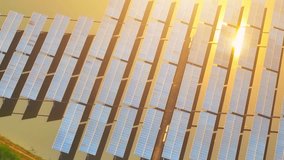 The solar power plant is a stunning sight during sunset. Rows upon rows of glistening solar panels, capturing the final rays of light and transforming them into renewable energy. Technology footage
