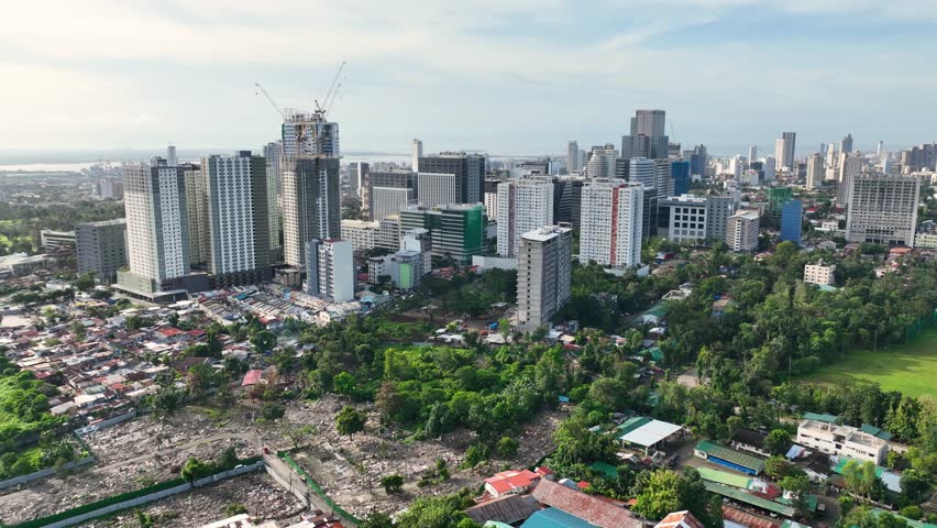 Aerial shot of the poor neighborhoods mixed in with new modern high-rises in Cebu City Philippines.