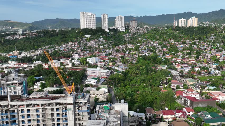 Aerial shot of the poor neighborhoods mixed in with new modern high-rises in Cebu City Philippines.