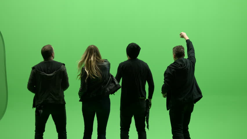 Group of four people from behind dancing and jumping on green screen in slow motion on green screen. They could be at a concert, or a party, or a protest, or... Royalty-Free Stock Footage #1103090475