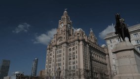 4K: Liver Building in Liverpool, Merseyside, UK. Wide Shot with King Edward VII Statue and Sunny Blue Sky. Stock Video Clip Footage