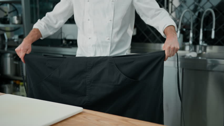 professional kitchen chef putting uniform tying apron before starting work restaurant and kitchen concept Royalty-Free Stock Footage #1103090711