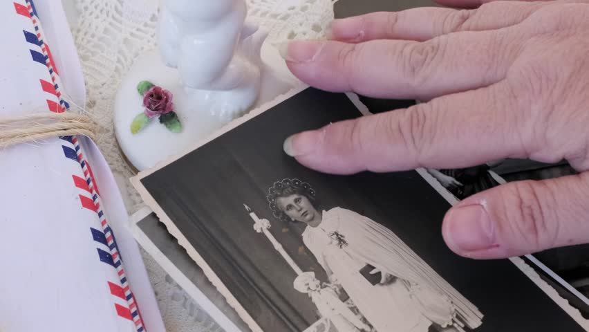 old vintage monochrome photographs, female hands hold retro family photos family archive last century, concept genealogy, memory ancestors, family ties, connection with clan, childhood memories Royalty-Free Stock Footage #1103092155