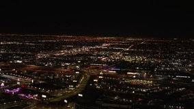 4K UHD slow motion video footage of Las Vegas at night from the air with city lights contrasting the darkness