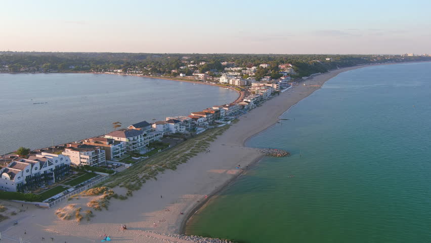 Poole, UK: Aerial view of city in England, famous seaside resort by Atlantic Ocean, Sandbanks Beach in summer at sunset - landscape panorama of United Kingdom from above