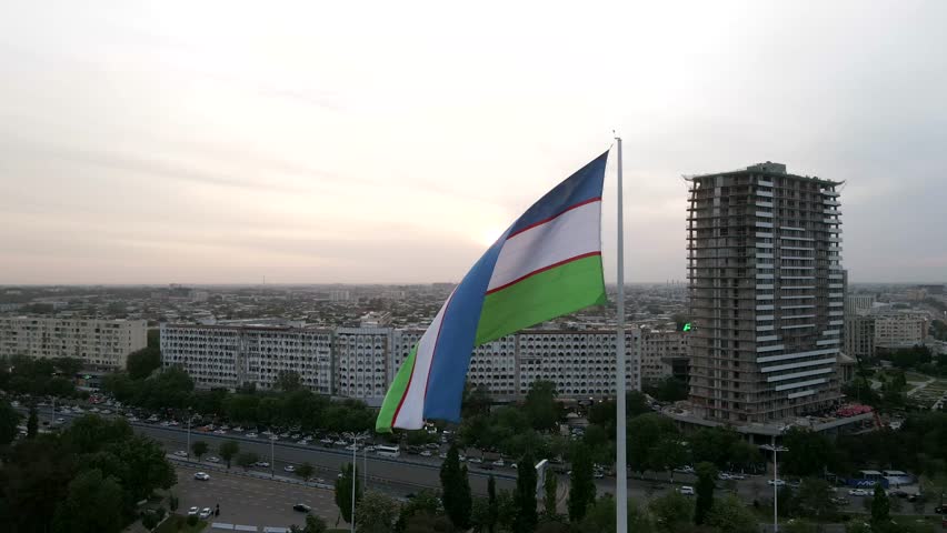 Aerial view of Majestic Uzbekistan National Flag at the Bunyodkor square in Tashkent city Royalty-Free Stock Footage #1103099873