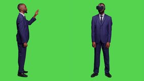 African american businessman using vr glasses in studio, working with virtual reality headset with interactive 3d simulation and hologram. Male startup worker with modern goggles on backdrop. - Powered by Shutterstock - Get 15% off with code: PIKWIZARD15