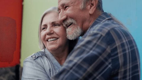 Happy multiracial senior couple hugging each other - Elderly family and love concept Stock Video