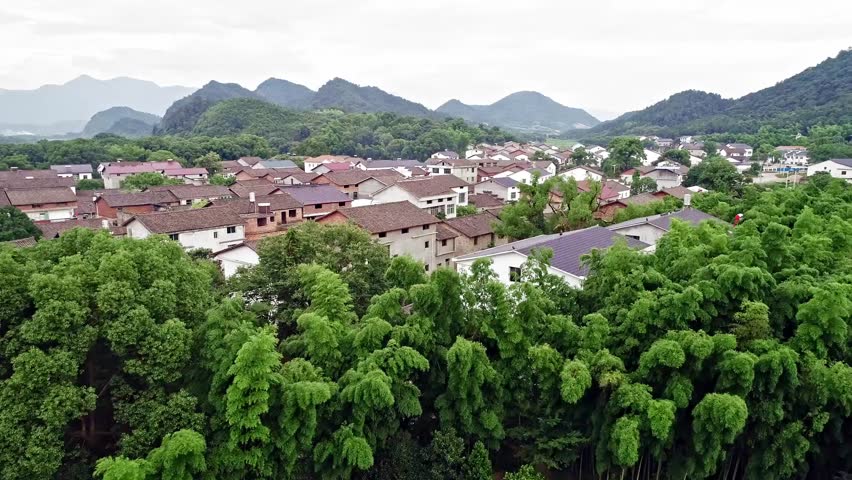 Aerial shot, beautiful houses, mountains and green trees in a small village in southern China | Shutterstock HD Video #1103104811