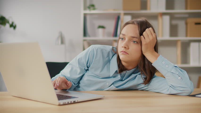 Upset Office Worker Who Failed to Cope With Work Tasks. The Frustrated Young Woman is not Satisfied With Her Work. The Woman Has Burnout at Work. Flexibility and Comfort of Work. Royalty-Free Stock Footage #1103107341