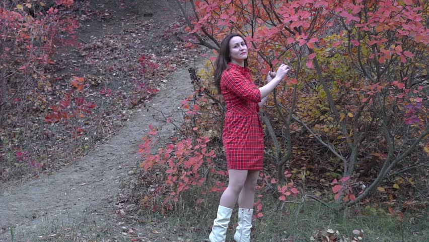 Slow Motion Woman standing in yellow autumn park. 